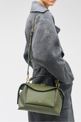 Profile view of model wearing the Oroton Mica Small Bowler in Dark Khaki and Embossed leather with smooth leather trims for Women