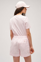 Profile view of model wearing the  Maggie Classic Tee in Palest Pink and Made from 100% cotton for Men
