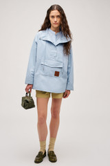 Profile view of model wearing the  Cotton Cagoule in Denim Blue and  for Women