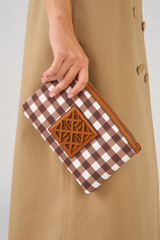 Profile view of model wearing the Oroton Boyd Printed Medium Pouch in Gingham and Canvas and leather trims for Women