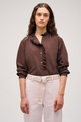 Profile view of model wearing the  Hazel Ruffle Blouse in Chocolate and Made from 100% poplin cotton  for Men