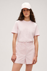 Profile view of model wearing the  Maggie Classic Tee in Palest Pink and Made from 100% cotton for Men