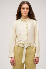 Profile view of model wearing the  Hazel Ruffle Blouse in Vanilla Crème and Made from 100% poplin cotton  for Men