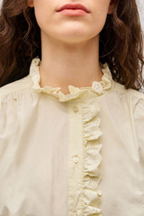 Profile view of model wearing the  Hazel Ruffle Blouse in Vanilla Crème and Made from 100% poplin cotton  for Men