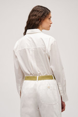 Profile view of model wearing the Oroton Wren Poplin Shirt in Antique White and Made from 100% poplin cotton  for Women