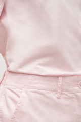 Profile view of model wearing the  Maggie Classic Tee in Palest Pink and Main: 100% Cotton Trim: 78% Cotton 22% Polyester for Men