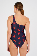 Profile view of model wearing the Oroton Dutch Tulip Asymmetric One Piece in North Sea and 78% polyamide, 22% elastane for Women