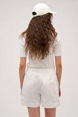 Profile view of model wearing the  Alfie Carpenter Short in Antique White and Crafted from cotton twill  for Men