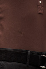Profile view of model wearing the  Margot Rib Henley in Chocolate and 92% Cotton / 8% Spandex for Men