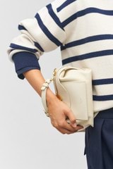 Profile view of model wearing the Oroton Mica Mini Bowler in Cashew and Pebble leather for Women