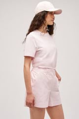 Profile view of model wearing the  Alfie Carpenter Short in Palest Pink and Crafted from cotton twill  for Men