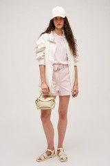Profile view of model wearing the  Maggie Classic Tee in Palest Pink and Made from 100% cotton for Men