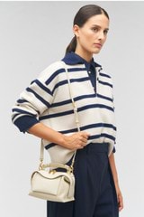 Profile view of model wearing the Oroton Mica Mini Bowler in Cashew and Pebble leather for Women