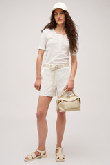 Profile view of model wearing the  Margot Rib Henley in Antique White and 92% Cotton / 8% Spandex for Men