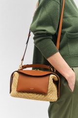 Profile view of model wearing the Oroton Mica Texture Small Bowler in Natural/Amber and Smooth leather for Women