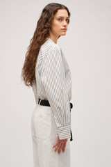 Profile view of model wearing the  Duo Stripe Shirt in Black and 100% Cotton for Women