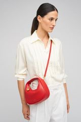 Profile view of model wearing the Oroton Clara Smooth Mini Bag in Dark Poppy and Smooth Leather Exterior for Women